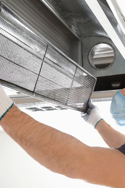 Cleans monitor. Group of workers clean modern office together at